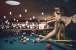 © RomanR - Beautiful woman with long hair playing billiard