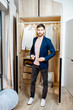 © rh2010 - Handsome man trying jacket in the wardrobe at home