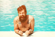 © Roman - Young sexy bearded man with wet hair and beard swimming in pool with blue water and drops sunny summer day outdoor. Design of summer vacation holiday concept. Advertising vacation.