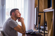 © qunica.com - Adult man behind a table with computer