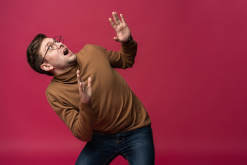 I'm afraid. Fright. Portrait of the scared man isolated on trendy pink studio background. Male half-length portrait. Human emotions, facial expression concept