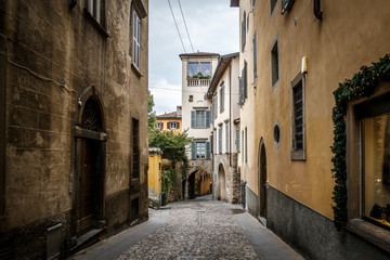 Wall Mural - Beautiful Old narrow street of small medieval city Citta Alta, perspective of street in Bergamo