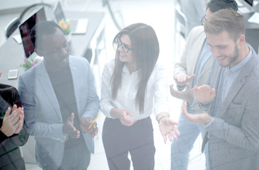 Wall Mural - close up.a group of successful young businessmen applauds