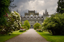 Turretted Inveraray Castle In Gothic Revival Style From The Flower Gardens With Dark Clouds In The Scottish Highlands Scotland UK