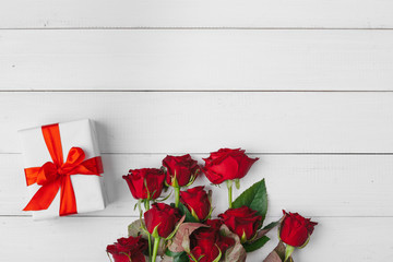 Wall Mural - St. Valentines Day. Red roses and gift box on wooden table