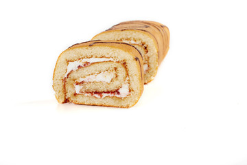 Wall Mural - Biscuit roll cut into pieces, on a white background.