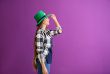 Beautiful Young Woman In Green Hat On Color Background. St. Patrick's Day Celebration