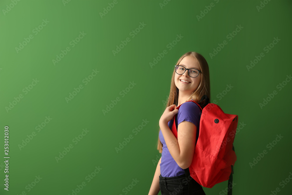 Cute schoolgirl on color background
