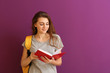 © Pixel-Shot - Schoolgirl with book on color background