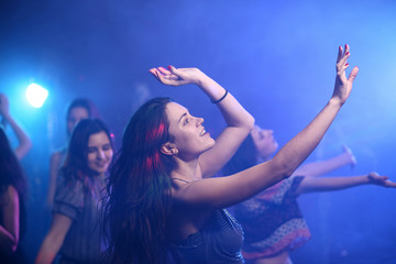 Beautiful young women dancing in night club