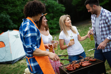 Group of friends having a barbecue party in nature