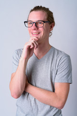 Wall Mural - Portrait of happy young handsome man with eyeglasses thinking