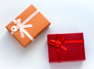 Two gift boxes in red and orange on a white background