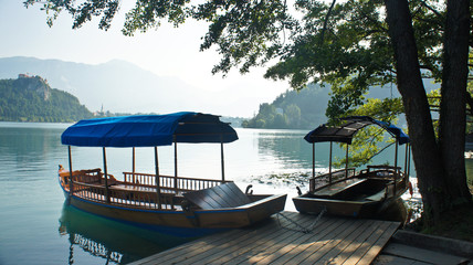 Scenic view of Lake Bled, Julian Alps and boats, sunny day, Bled, Slovenia