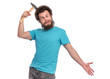 Crazy bearded Man is hitting him self in head with Hammer and making grimace - Silly face. Guy with funny Curly Hair, isolated on white background. Emotions, and signs concept.