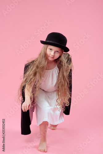 Funny Cute Serious Little Girl With Long Blonde Hair In Black