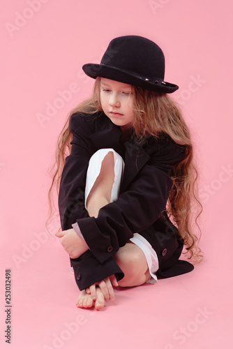 Funny Cute Serious Little Girl With Long Blonde Hair In Black