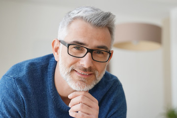 Wall Mural - Portrait of smiling man with grey hair and glasses