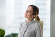 © fizkes - Relaxed calm businesswoman resting in ergonomic chair lounging at work