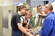 © industrieblick - Group of young people in technical vocational training with teacher