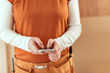 © Bits and Splits - Female carpenter using smartphone