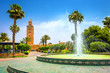 Cityscape with beautiful fountain in park. View of Koutoubia Mosque. Marrakesh, Morocco, North Africa