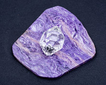 Herkimer Diamond Placed On Top Grade Charoite Polished Slab From Sakha Republic, Siberia, Russia. On Black Background. Double-terminated Quartz.