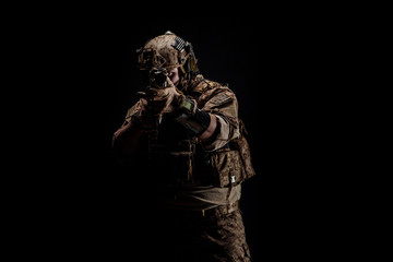 Wall Mural - Special forces United States soldier or private military contractor holding rifle. Image on a black background. war, army and people concept