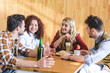 © LIGHTFIELD STUDIOS - handsome and attractive friends talking and smiling at cafe