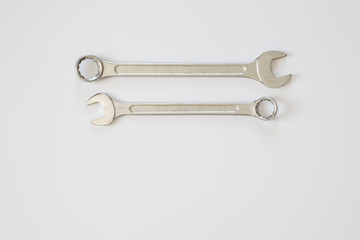 Two spanners on a light white background. Empty space for your writing.