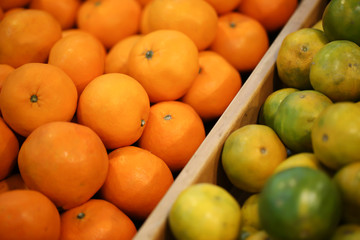 Wall Mural - Close up view of orange fruits on the shelf in the supermarket.