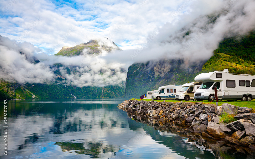 Campervan RV vehicles at norwegian camping by a fjord - obrazy, fototapety, plakaty 
