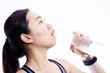 © DG PhotoStock - Beautiful Asian sport women drinking water in bottle close up on white background.