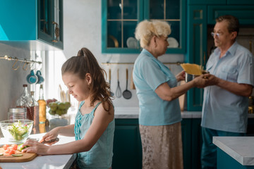 Wall Mural - Granddaughter helps to cook