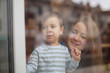 © Максим Галінский - happy family, blonde mother and her beautiful and charismatic little son, the boy is having fun day in a cozy cafe. selective focus, noise effect