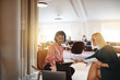 © Flamingo Images - Smiling businesswomen discussing work on a laptop in an office