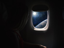 Woman In Spaceship Looks Out The Porthole. Commercial Space Travel Concept.