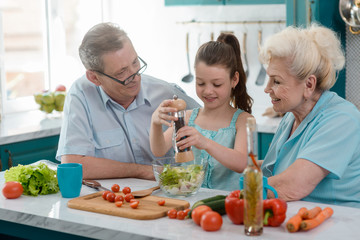 Wall Mural - Proud grandparents and their granddaughter