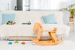 © LIGHTFIELD STUDIOS - modern interior design of living room with couch, car toys and wooden rocking horse