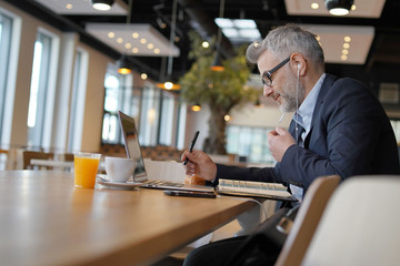 Wall Mural - Businessman working in modern office cafeteria