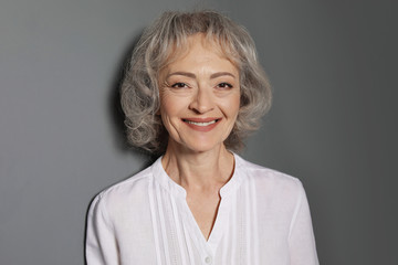 Wall Mural - Portrait of mature woman on grey background