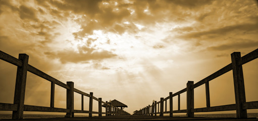 Wall Mural - perspective view of wooden bridge extending into the sea on the beach
