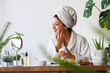 © lordn - Young woman cleaning face with natural cosmetics. Clean fresh skin care.
