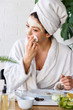 © lordn - Young woman applying face mask at home. Natural Skin Care Routine For Glowing Skin.