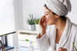 © lordn - Young woman cleaning face with natural cosmetics. Clean fresh skin care.