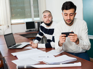 Student watching at smartphone