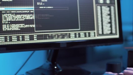 cybercrime, hacking and technology concept - female hacker in dark room creating code or using computer virus program for cyber attack