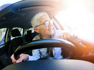 Wall Mural - Happy woman driving a car