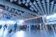 © Nikolay N. Antonov - Inside of Airport with a lot of people. Airport interior with a flight information board. Blurred defocused image