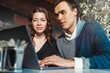 © Akaberka - Young man and woman working in front of the laptop. Team meeting,work process.